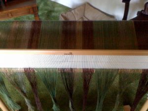Warp pulled through heddle, ready to thread heddle and tie up.